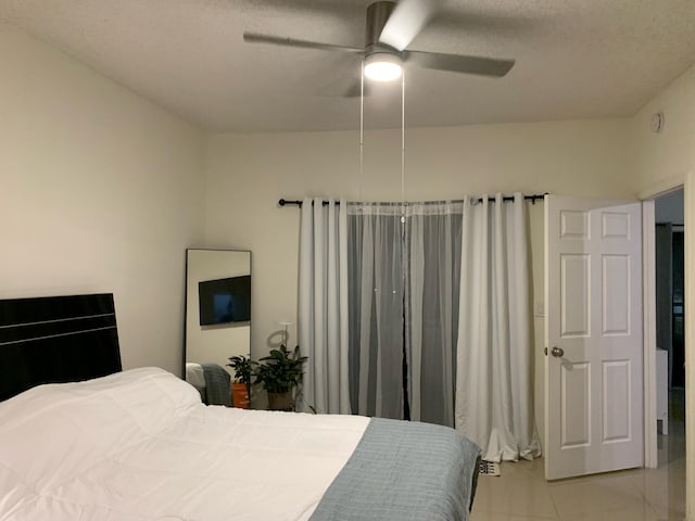 bedroom featuring light tile patterned flooring and ceiling fan