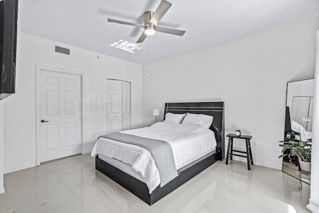 bedroom featuring ceiling fan and a textured ceiling