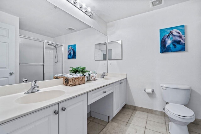 bathroom featuring walk in shower, tile patterned floors, vanity, and toilet