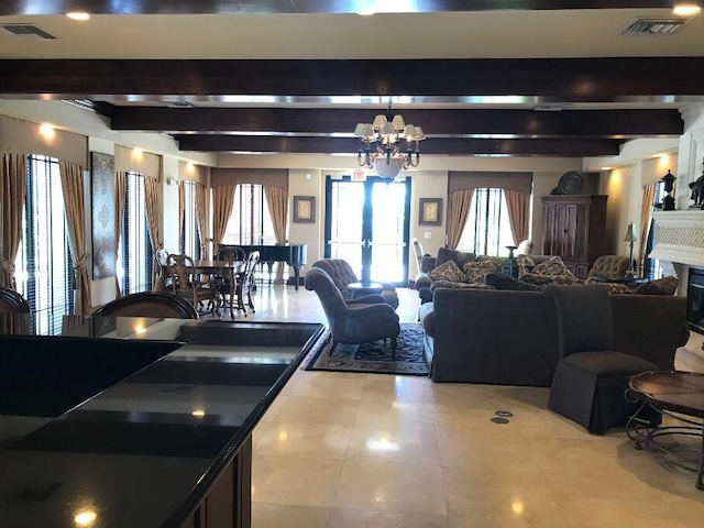 living room with beamed ceiling and an inviting chandelier