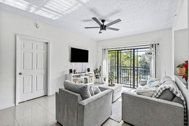 tiled living room with a textured ceiling and ceiling fan