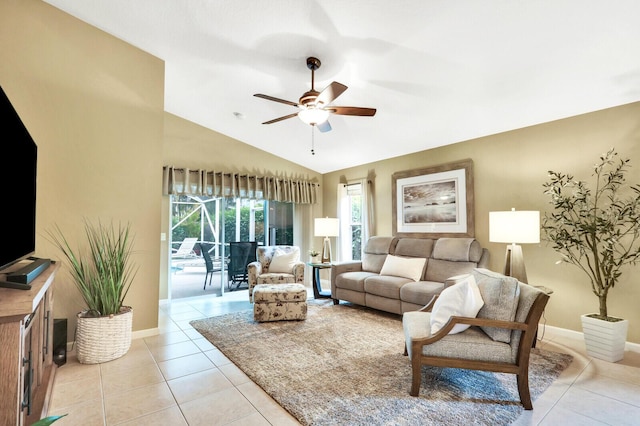 living room featuring lofted ceiling, light tile patterned floors, and ceiling fan