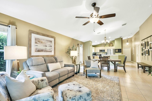 living room featuring ceiling fan with notable chandelier, lofted ceiling, and light tile patterned floors