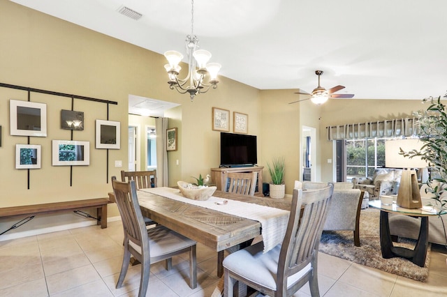 tiled dining room with ceiling fan with notable chandelier and vaulted ceiling