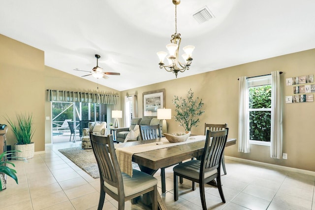 dining space with light tile patterned flooring, lofted ceiling, and ceiling fan with notable chandelier