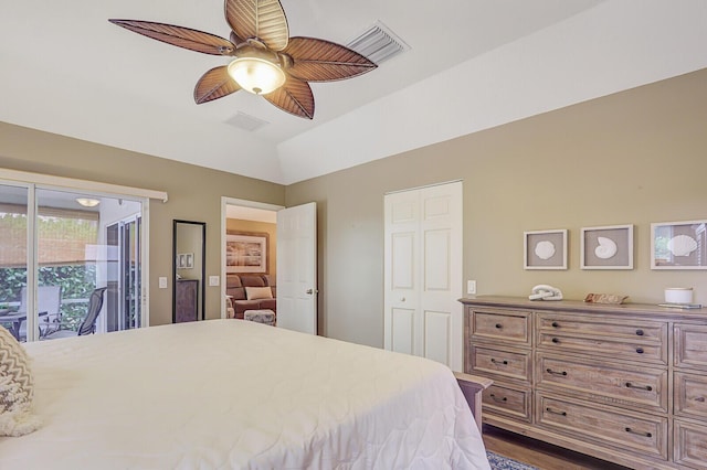 bedroom featuring ceiling fan, access to exterior, dark hardwood / wood-style flooring, and vaulted ceiling