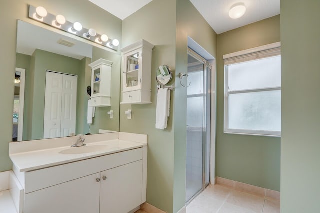 bathroom with walk in shower, tile patterned floors, and vanity