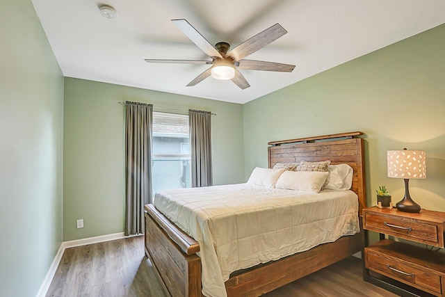 bedroom with dark hardwood / wood-style floors and ceiling fan