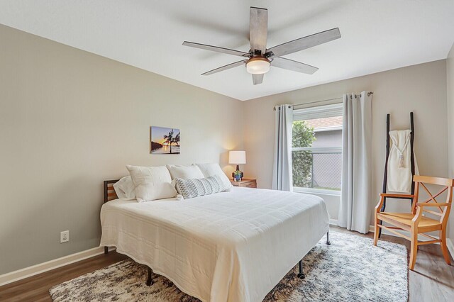 bedroom with hardwood / wood-style flooring and ceiling fan