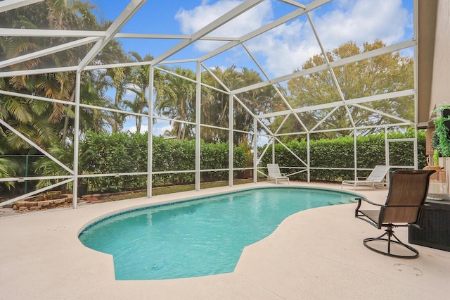 view of swimming pool featuring a lanai and a patio area