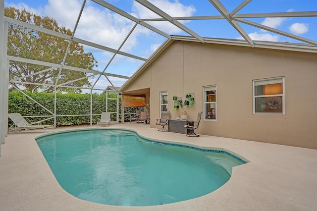 view of swimming pool with a lanai and a patio