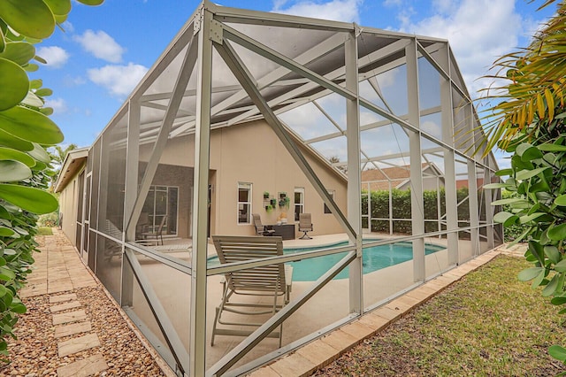 view of swimming pool with a patio and a lanai