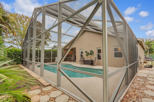 view of swimming pool with a lanai and a patio area