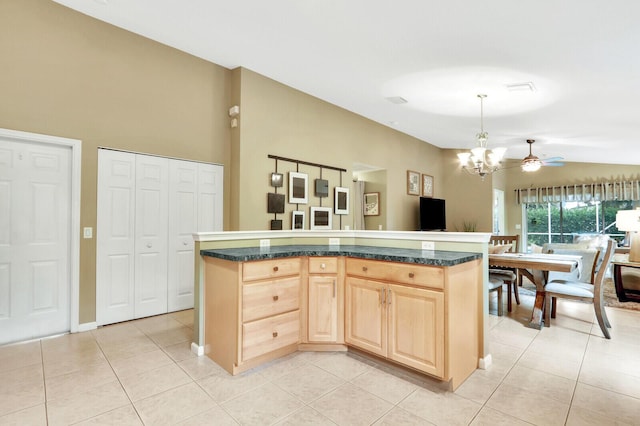 kitchen featuring a kitchen island, light brown cabinets, lofted ceiling, and decorative light fixtures