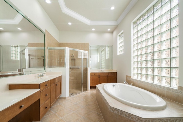 bathroom with shower with separate bathtub, tile patterned flooring, vanity, a raised ceiling, and crown molding