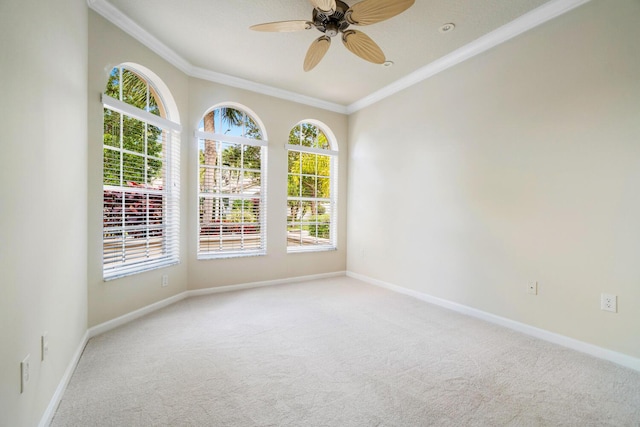 carpeted empty room featuring crown molding and ceiling fan