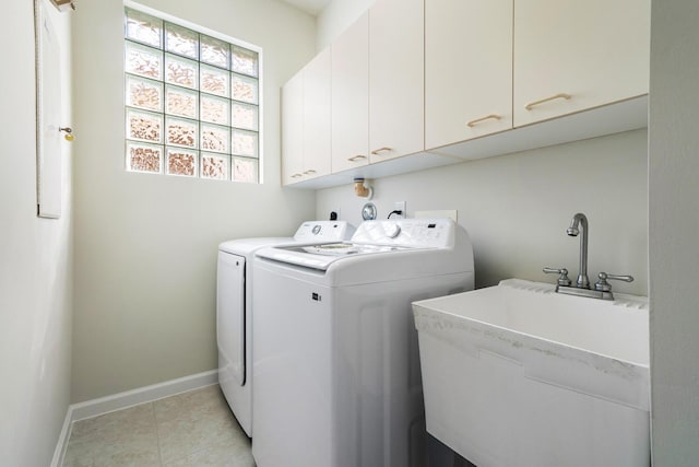 laundry room featuring light tile patterned flooring, cabinets, sink, and washing machine and clothes dryer