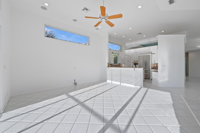 unfurnished living room featuring light tile patterned floors, crown molding, and ceiling fan