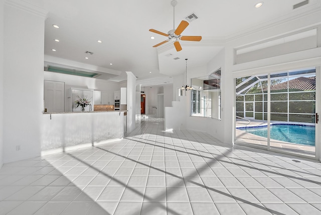 unfurnished living room with ceiling fan, ornamental molding, and light tile patterned floors