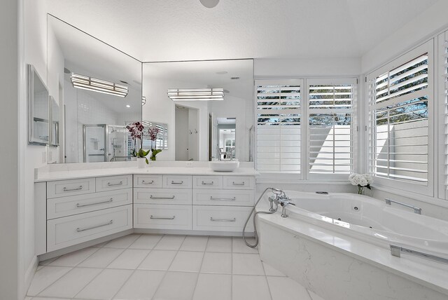 bathroom featuring vanity, plus walk in shower, and tile patterned flooring