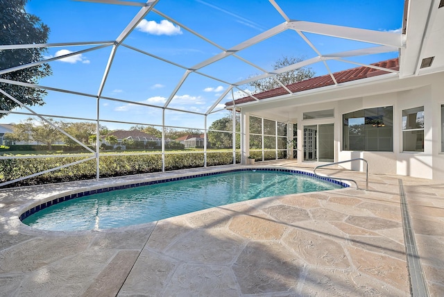 view of swimming pool featuring a lanai and a patio