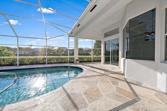 back of house featuring a lanai, a lawn, and a patio area