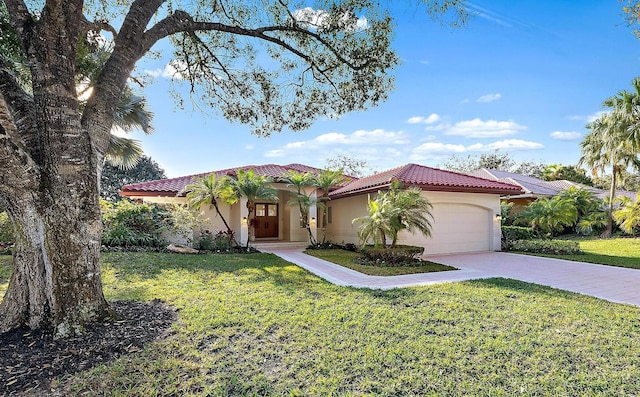 mediterranean / spanish-style house with a garage and a front lawn