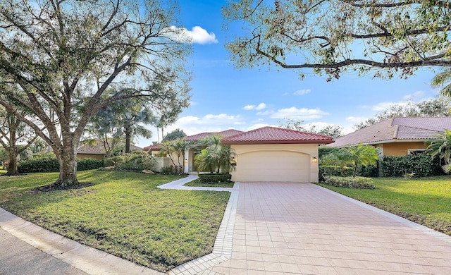 mediterranean / spanish home with a garage and a front yard