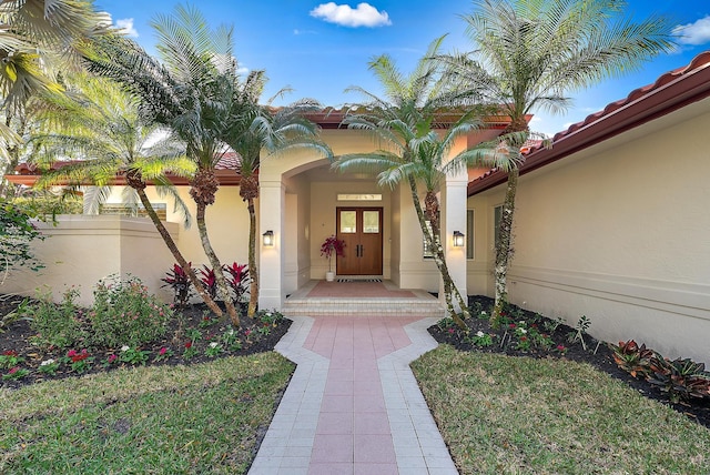 doorway to property with a yard