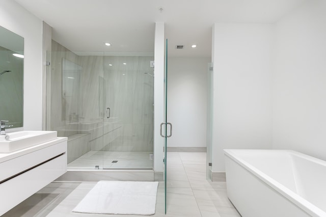 bathroom featuring vanity and separate shower and tub