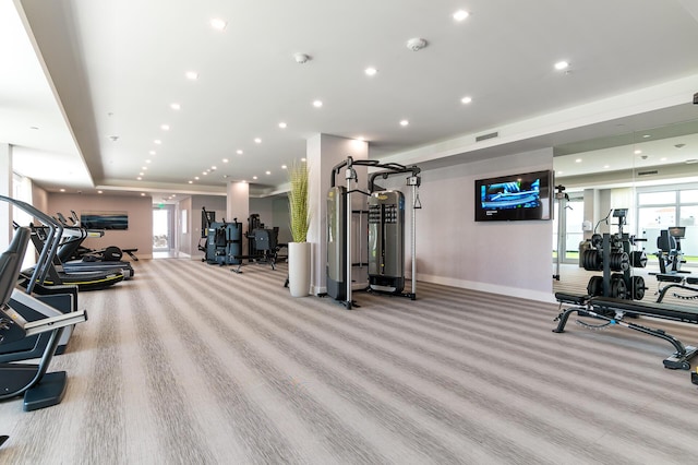 exercise room featuring light colored carpet