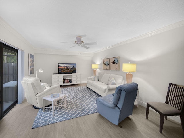 living room with crown molding, ceiling fan, and light hardwood / wood-style flooring