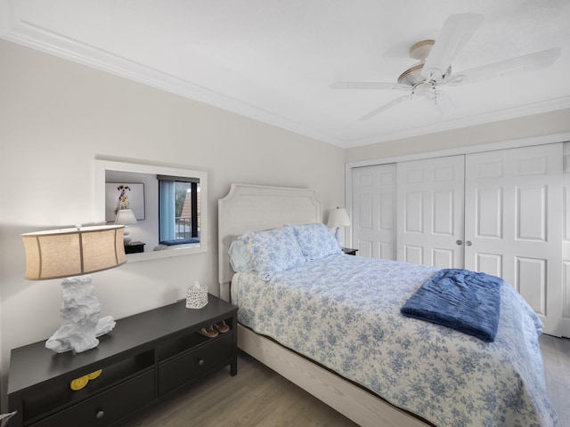 bedroom with hardwood / wood-style flooring, crown molding, and a closet