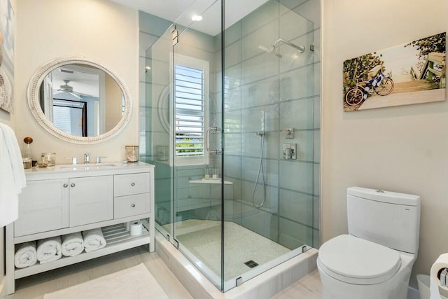 bathroom featuring vanity, toilet, and walk in shower