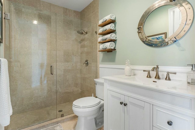 bathroom with vanity, an enclosed shower, and toilet