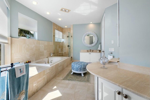 bathroom featuring tile patterned flooring, vanity, and separate shower and tub