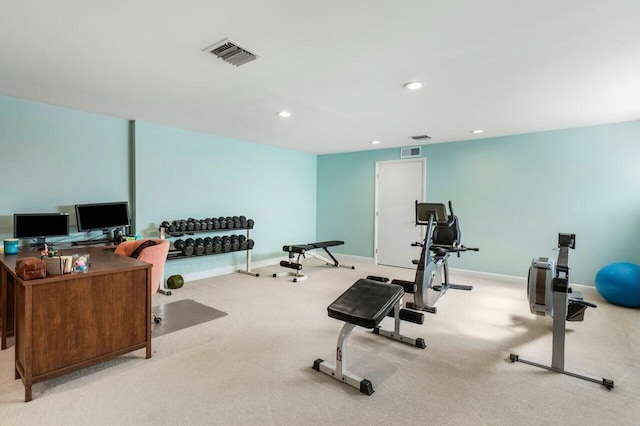 exercise area featuring light colored carpet