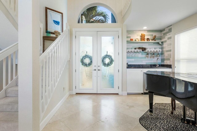 foyer entrance with sink and french doors