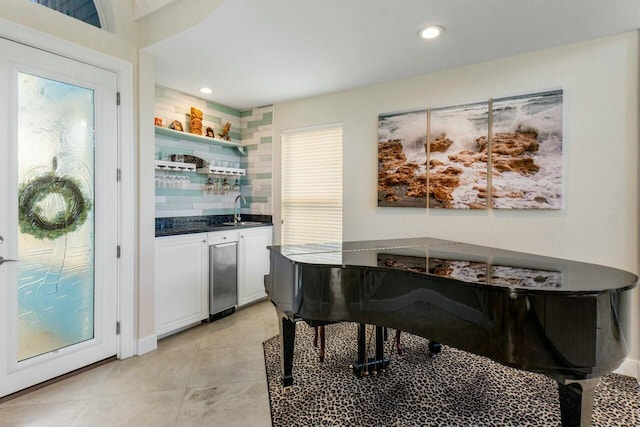 miscellaneous room featuring light tile patterned flooring, a healthy amount of sunlight, wet bar, and wine cooler