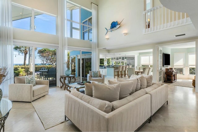 living room with a towering ceiling and a wealth of natural light