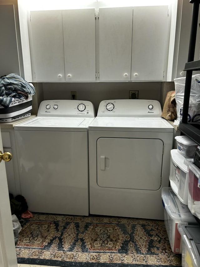 laundry area featuring cabinets and washing machine and clothes dryer