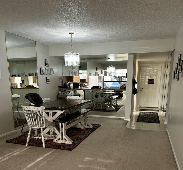 dining room with an inviting chandelier, a textured ceiling, and carpet