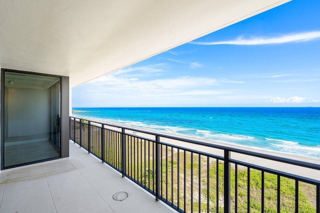 balcony with a water view and a beach view