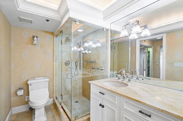 bathroom with toilet, vanity, visible vents, baseboards, and a stall shower