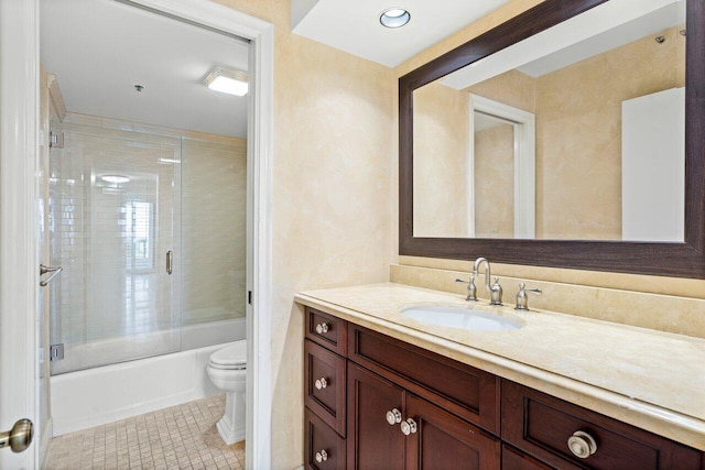 full bathroom with toilet, shower / bath combination with glass door, tile patterned floors, and vanity