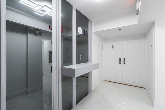 bathroom featuring marble finish floor