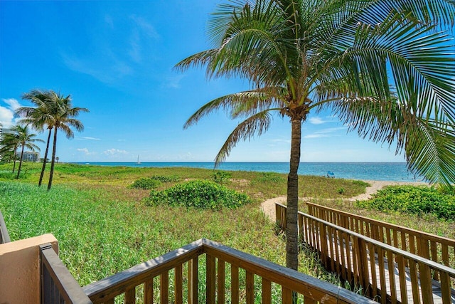 exterior space with a water view and a beach view