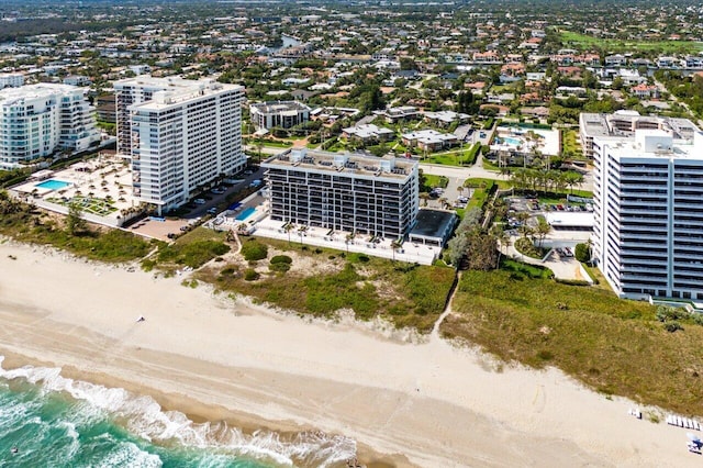 aerial view featuring a water view, a view of city, and a beach view