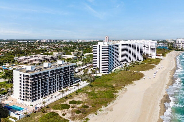 birds eye view of property with a view of the beach, a water view, and a city view