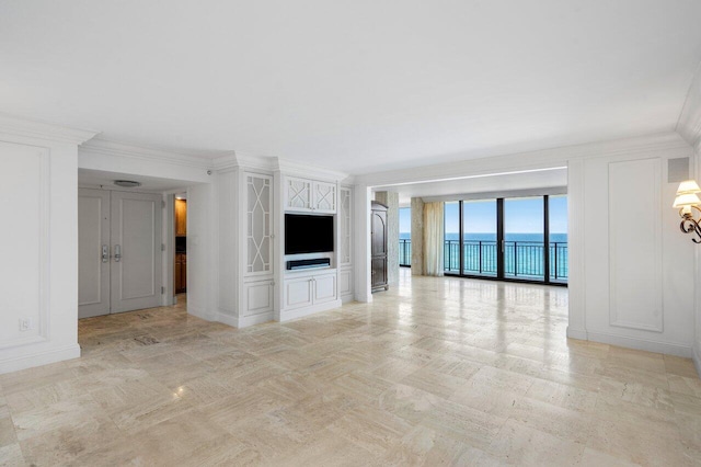 unfurnished living room with a decorative wall and crown molding